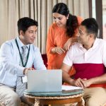 Financial advisor discussing with Indian family at home Financial advisor discussing with Indian family at home
